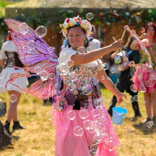 Natalie Starr Storyteller ORF A woman dressed like a fairy surrounded by bubbles