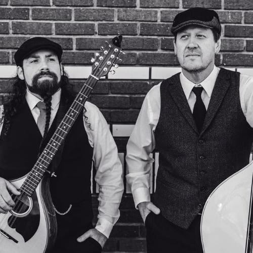 2 celtic music performers holding their insturments